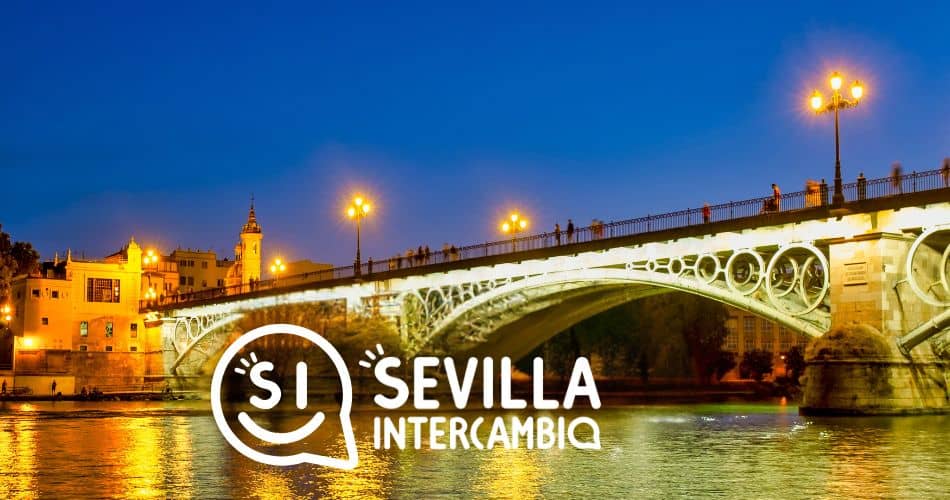 Gente caminando por el Puente de Triana al atardecer